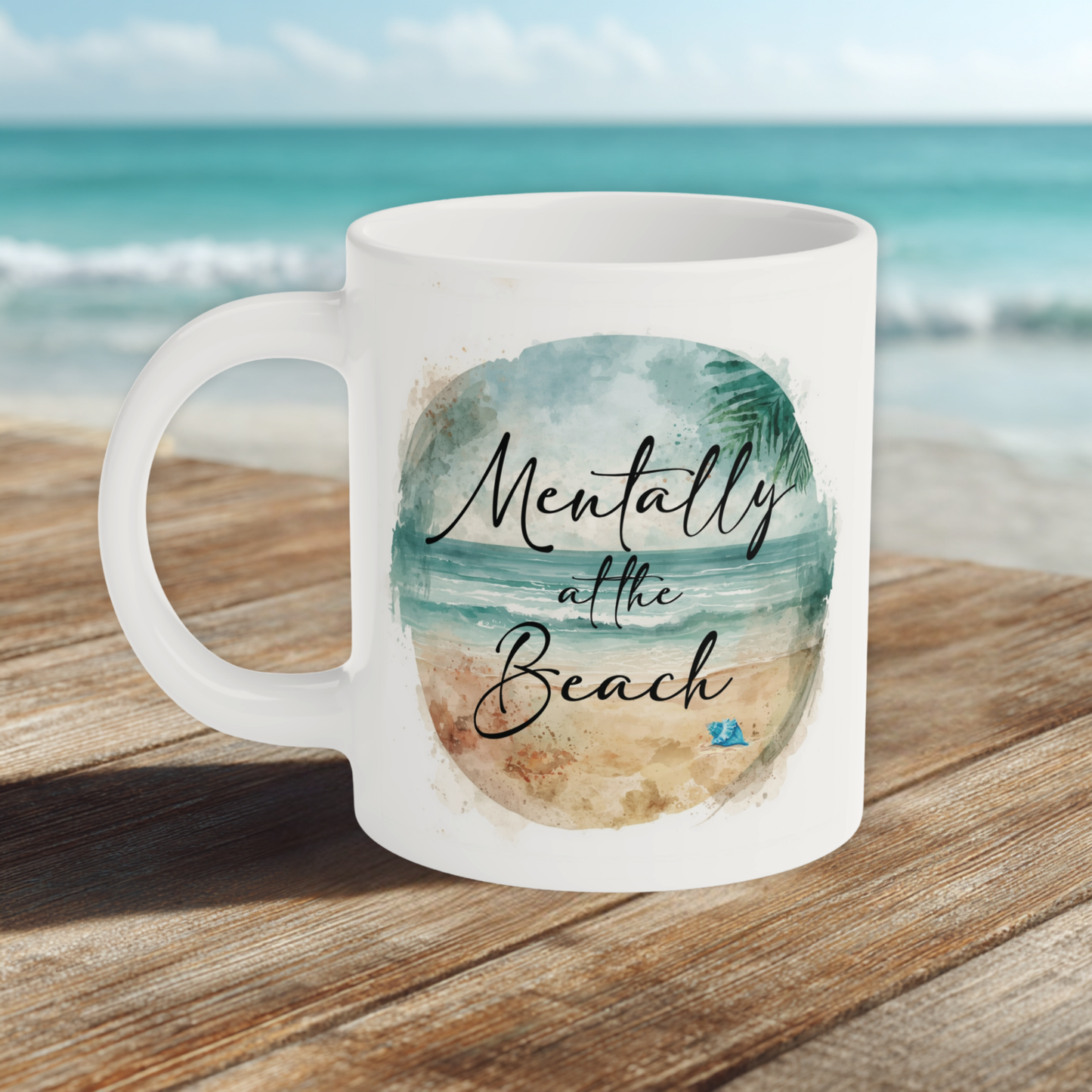 Mug with 'Mentally at the Beach' text on a wooden surface with a beach background