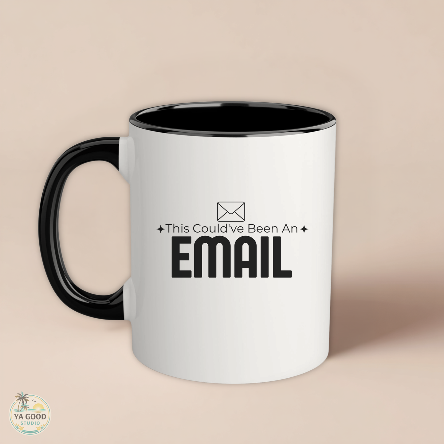 White mug with black interior and handle, featuring text 'This Could've Been An EMAIL' on a beige background.