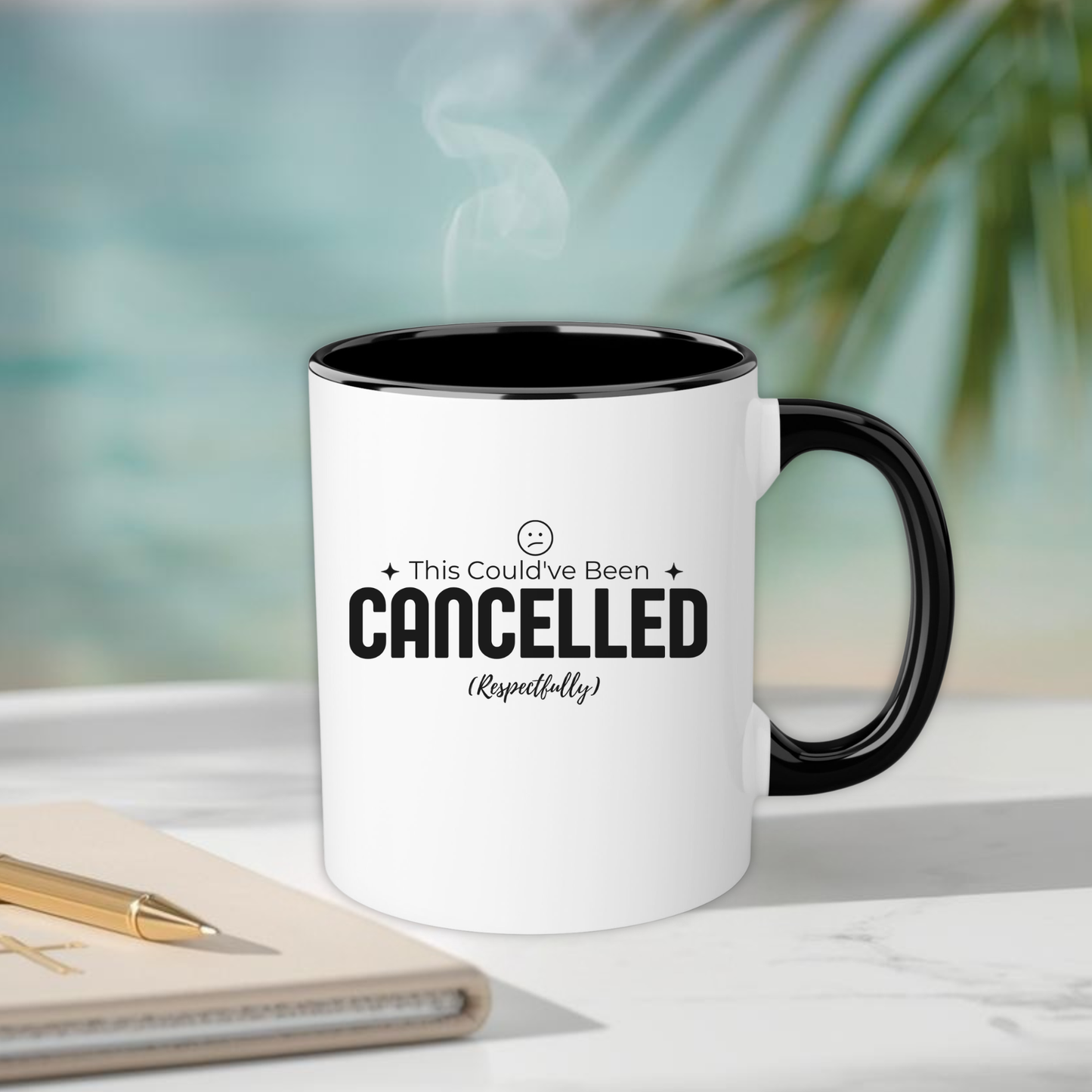 White mug with black interior and handle, featuring text, on a blurred background with a plant.