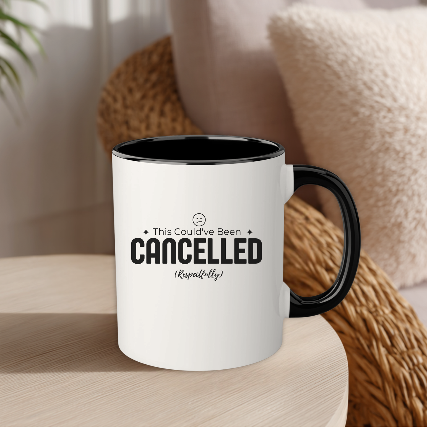 White mug with black interior and handle on a wooden surface, featuring text.