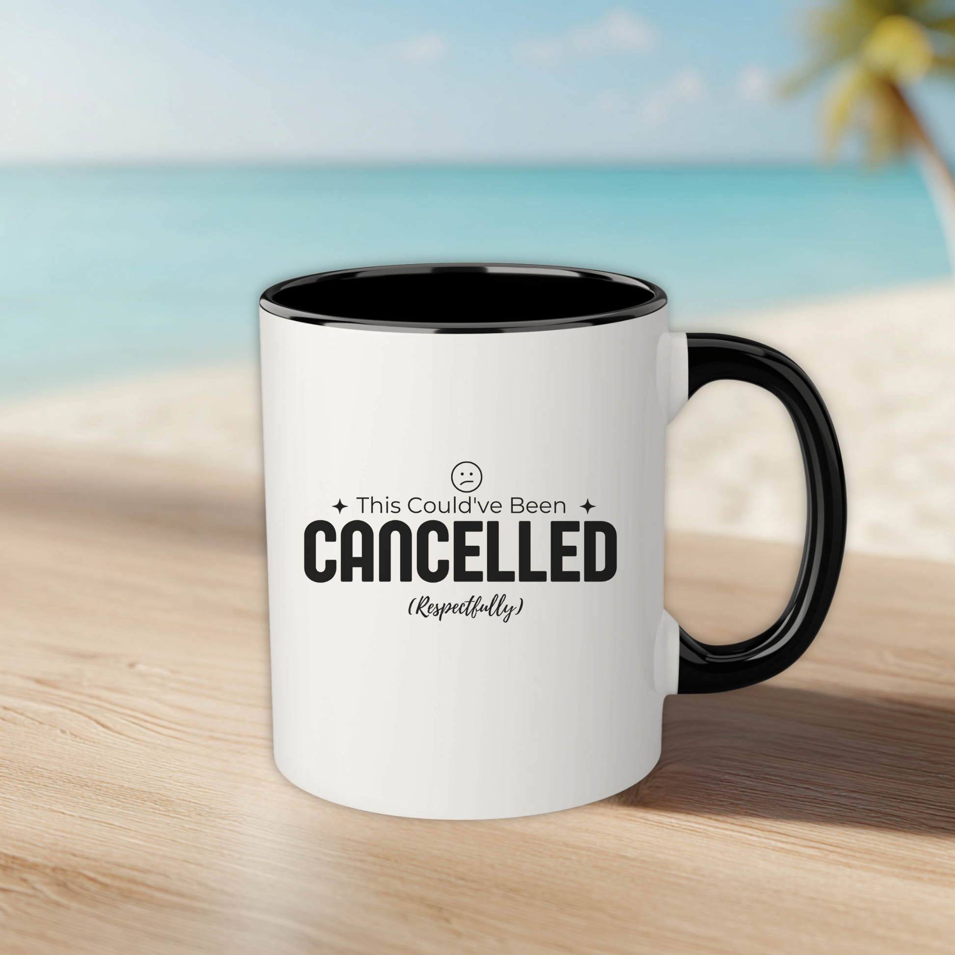 White mug with black interior and handle on a wooden surface with a beach background