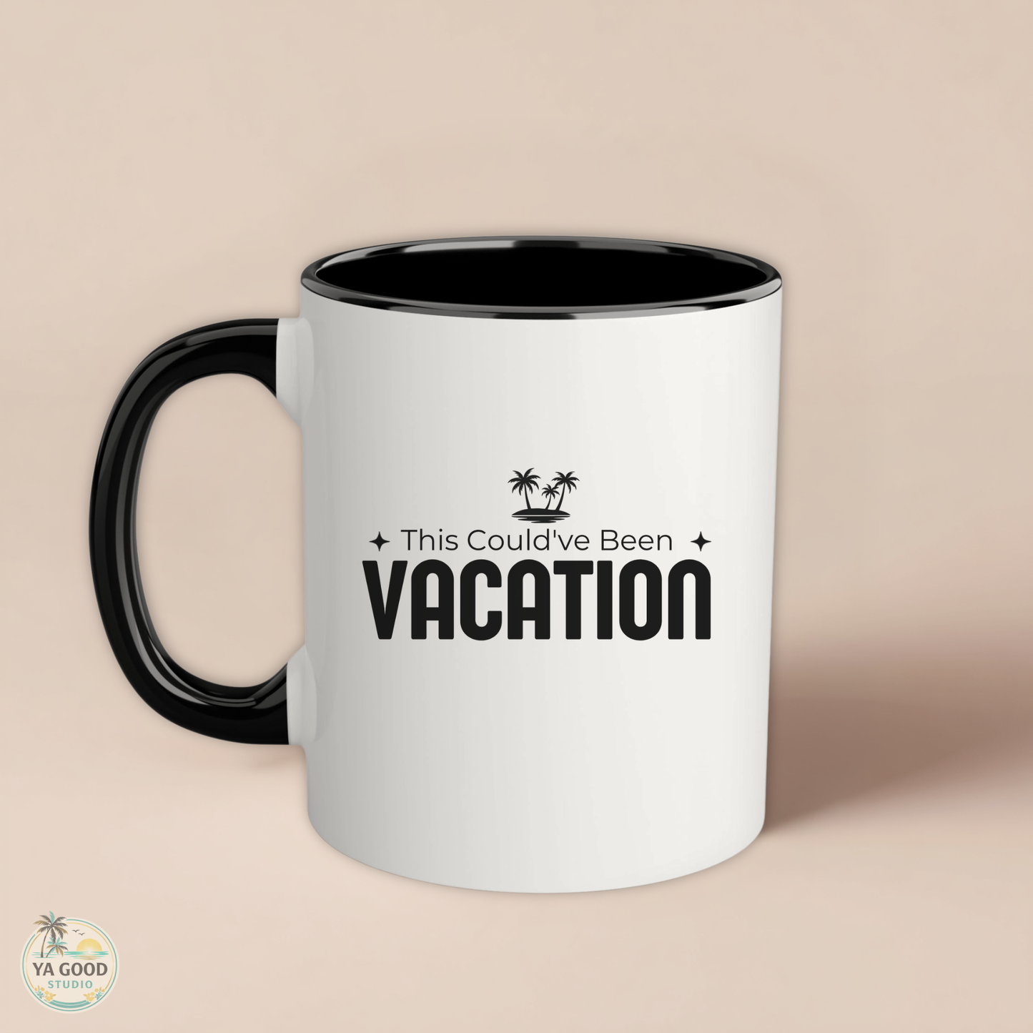 White mug with black interior and handle, featuring 'This Could've Been Vacation' text on a beige background.