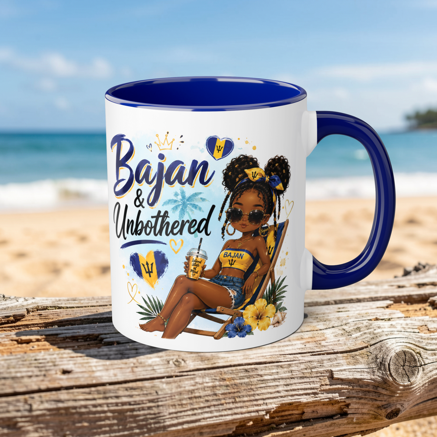 Mug with a design of a woman sitting on a beach, text 'Bajan & Unbothered', and blue interior and handle on a wooden surface with a beach background.
