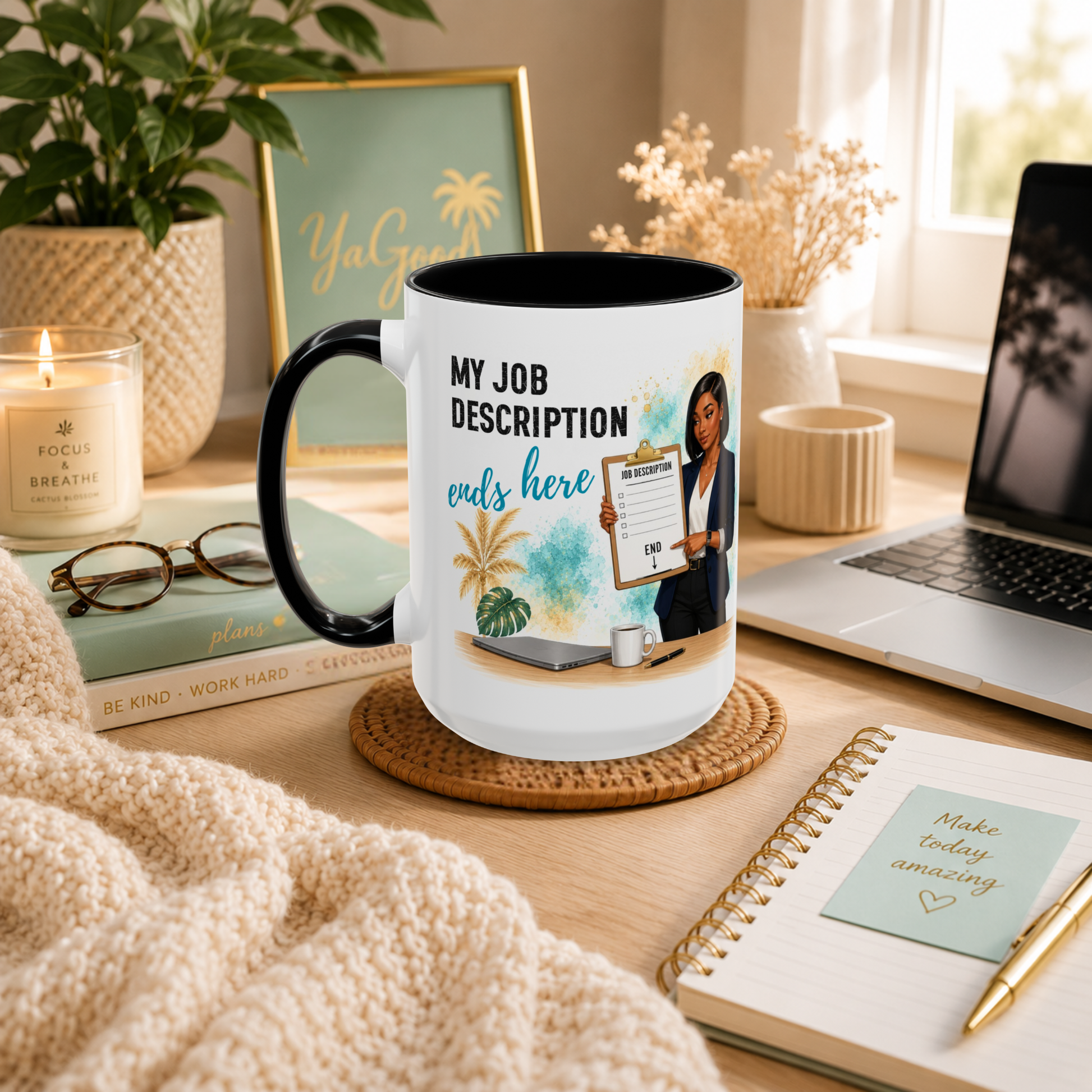 A white ceramic mug with a black handle and interior is styled on a wooden desk in a warm, cozy workspace setting. The mug features a customizable graphic with the text 'MY JOB DESCRIPTION ends here' and a photo of a woman holding a clipboard.