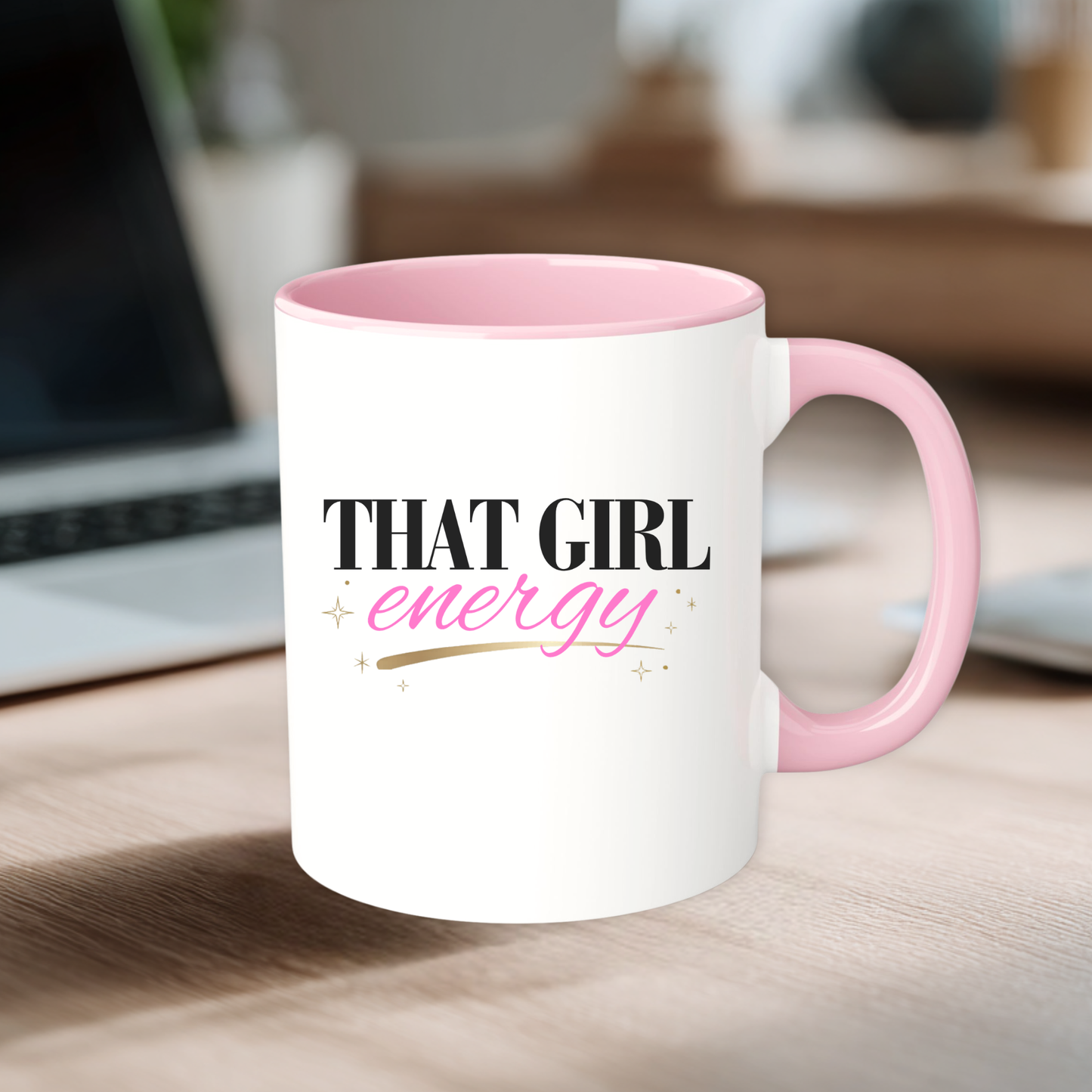 White mug with pink interior and handle, featuring 'That Girl Energy' text on a desk.